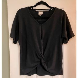 Black short sleeve top with front twist. Size large. Preowned. EUC